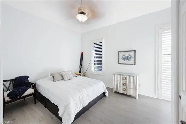 Bedroom featuring ceiling fan and light hardwood / wood-style flooring