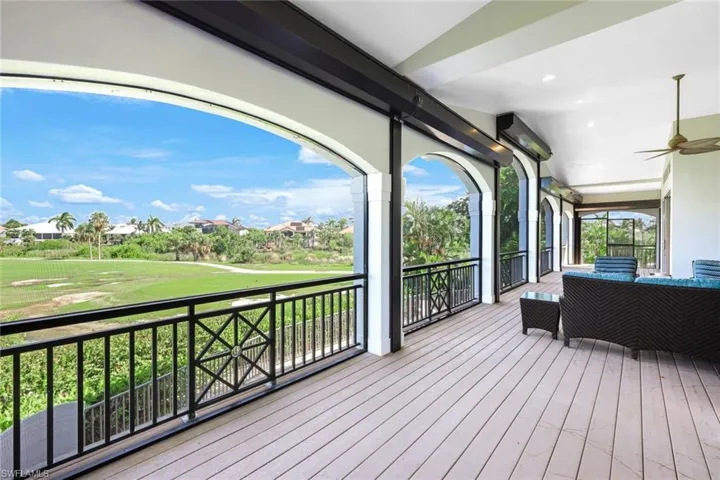 Wooden terrace with ceiling fan and an outdoor hangout area