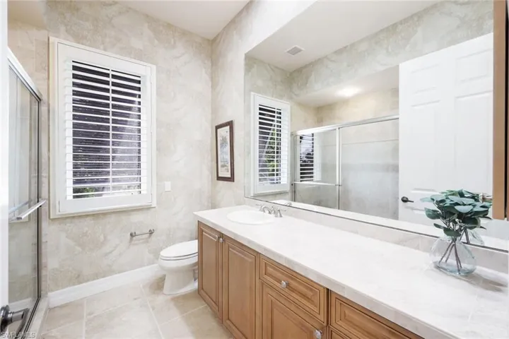 Bathroom featuring toilet, vanity, and tile patterned flooring
