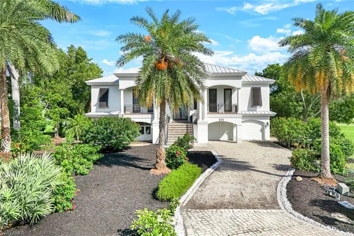 View of front of house with a garage and a balcony