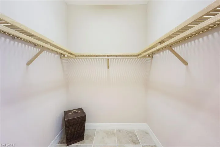 Walk in closet with light tile patterned floors