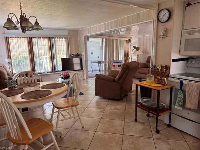 Dining area featuring a chandelier and light tile patterned flooring
