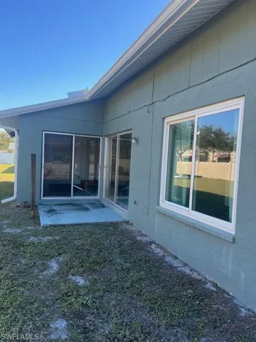 Back of house featuring a patio and a lawn