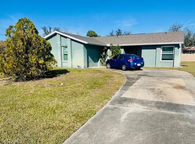 Single story home featuring a front yard