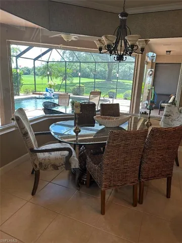 Tiled dining room with a notable chandelier