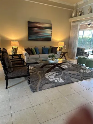 Living room with crown molding and tile patterned flooring