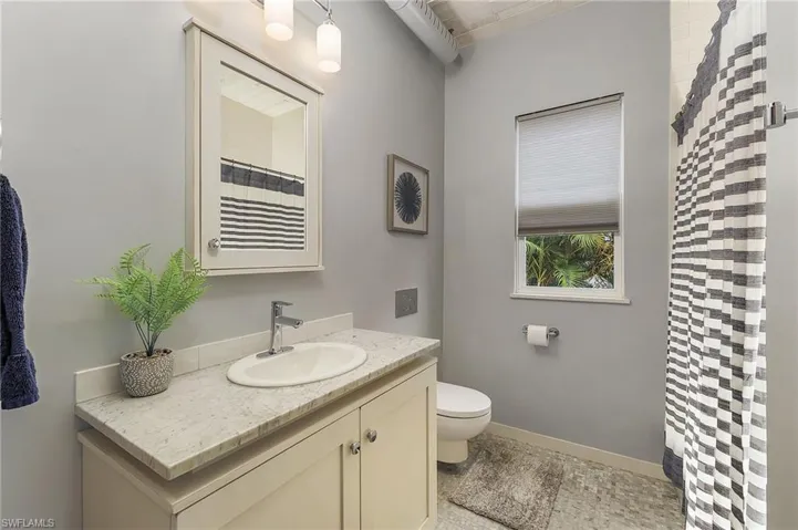 Bathroom featuring vanity, toilet, and tile patterned flooring
