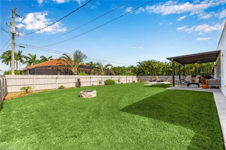 View of yard featuring a patio area and an outdoor fire pit