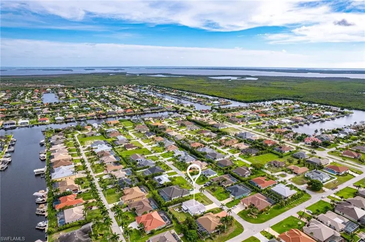 Birds eye view of property with a water view
