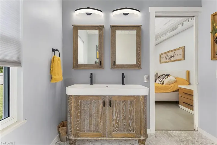 Bathroom featuring plenty of natural light and vanity