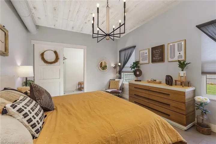 Bedroom featuring wood ceiling and a chandelier