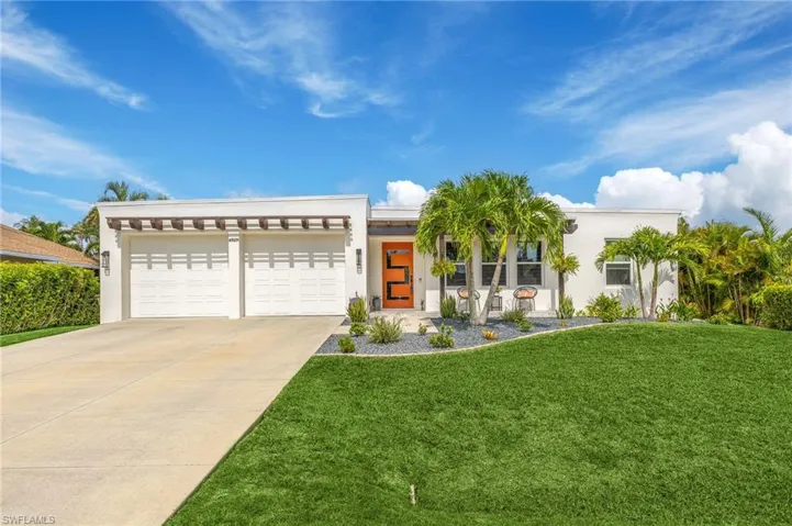 View of front of property with a garage and a front yard