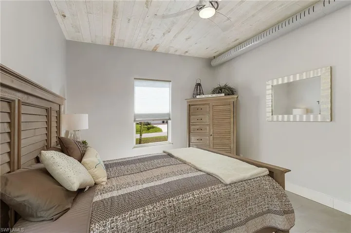 Bedroom with wooden ceiling and ceiling fan
