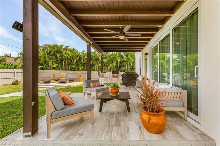 Deck with a patio area, an outdoor hangout area, ceiling fan, and grilling area