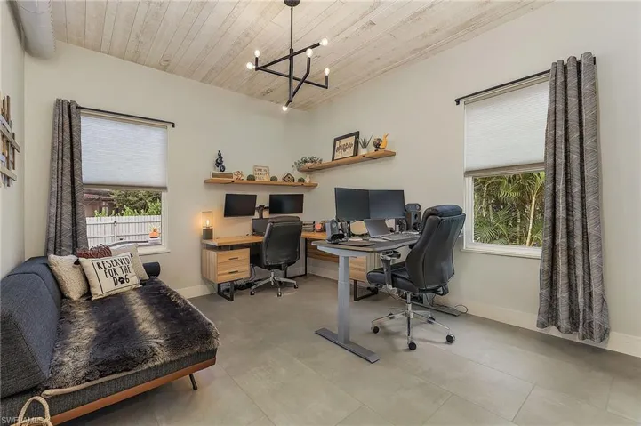 Office with light tile patterned floors, a chandelier, and wooden ceiling