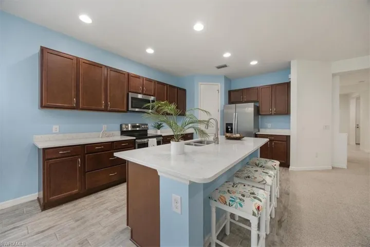 Large Island offers an additional informal eating space with a counter height bar.