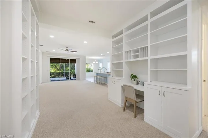 Gallery/Flex space is built in with a desk, cabinets and shelving, with room for another desk