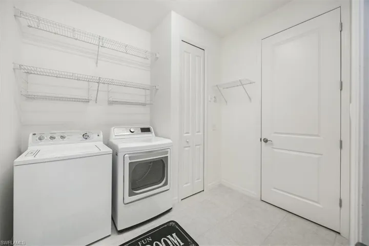 Large laundry room provides plenty of storage shelves and closet.  Also not shown a close line handy for hang drying.