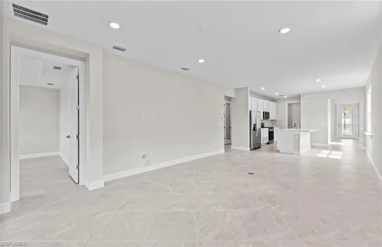 Unfurnished living room featuring sink