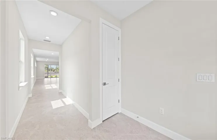 Corridor featuring light tile patterned floors