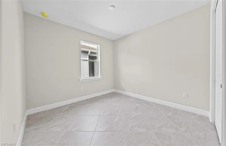 Unfurnished room with light tile patterned flooring