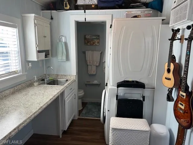 Bathroom featuring wood-type flooring, sink, a wall mounted AC, and toilet