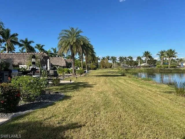 View of community with a water view and a lawn