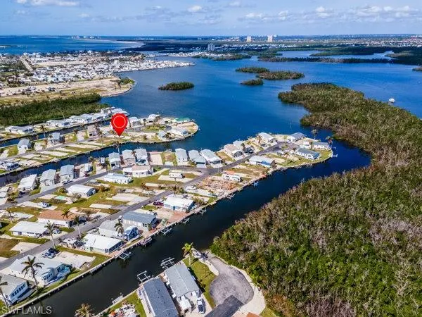 Birds eye view of property with a water view