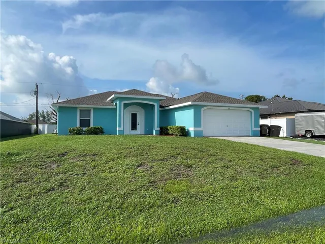 Ranch-style home with stucco siding, concrete driveway, an attached garage, and a shingled roof