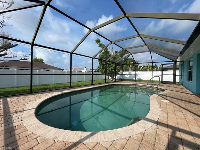 View of swimming pool with a sunroom, a lanai, and a patio area