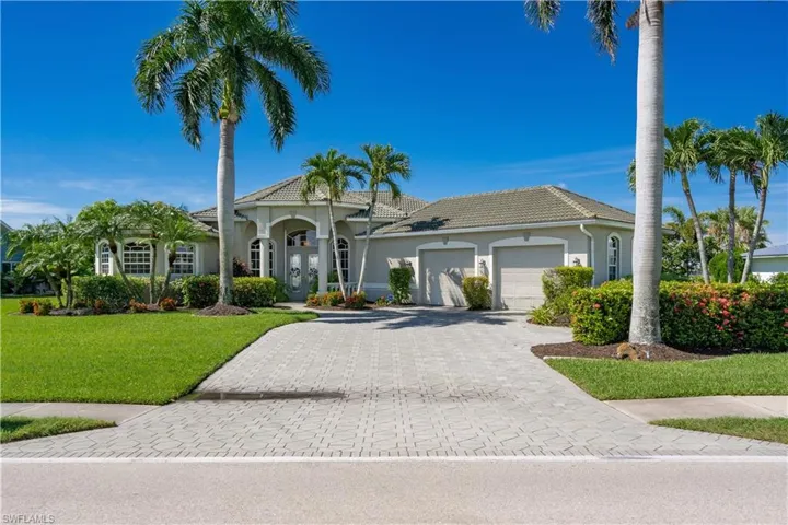 Mediterranean / spanish house featuring a garage and a front lawn