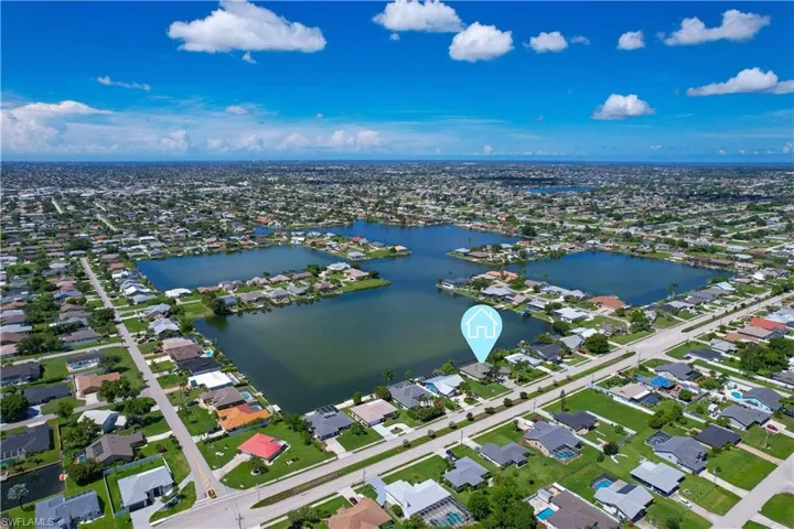 Birds eye view of property with a water view
