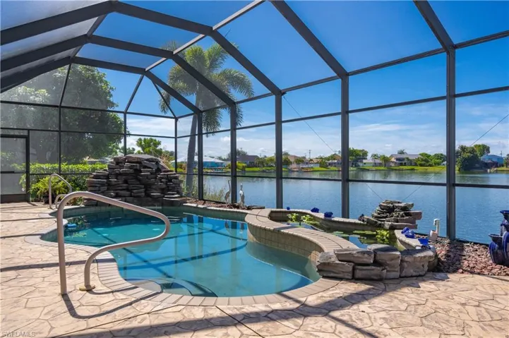 View of pool featuring a water view and a lanai