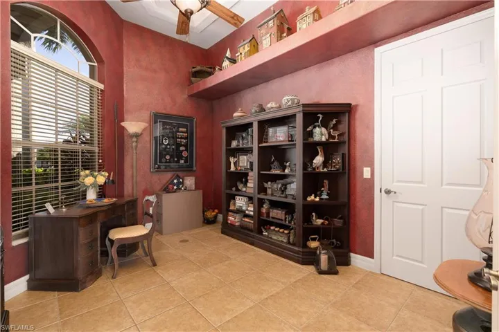 Tiled office featuring ceiling fan