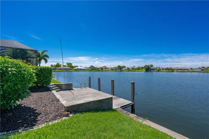 Dock area with a water view and glass enclosure