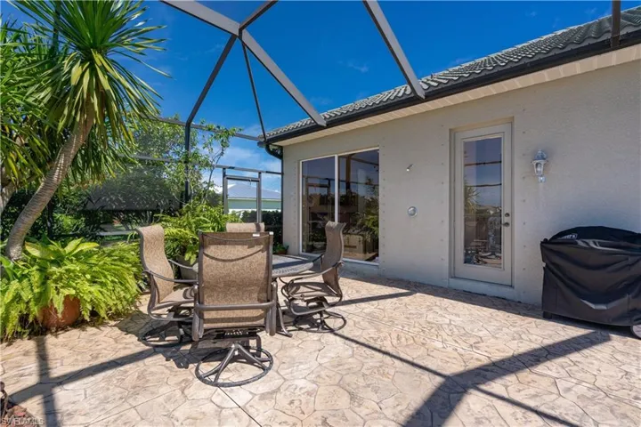View of patio featuring a lanai