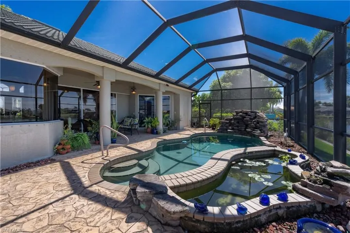 View of pool featuring, a lanai, a patio area, and ceiling fan