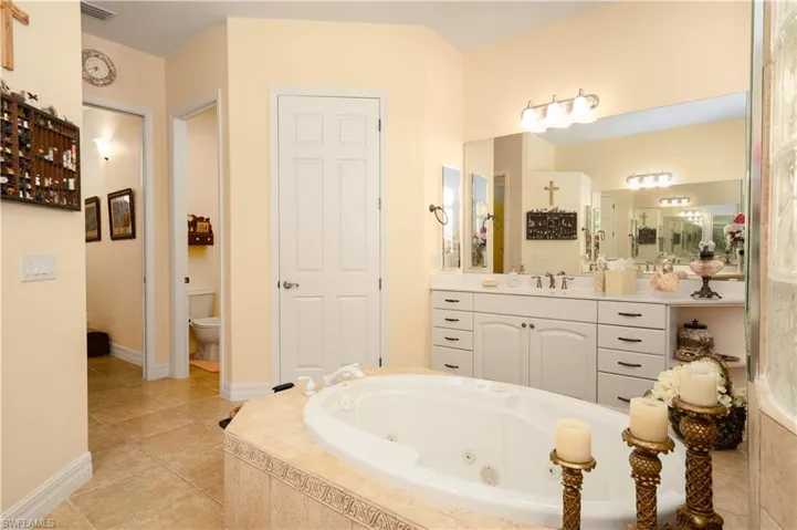 Bathroom featuring tile patterned flooring, toilet, and vanity