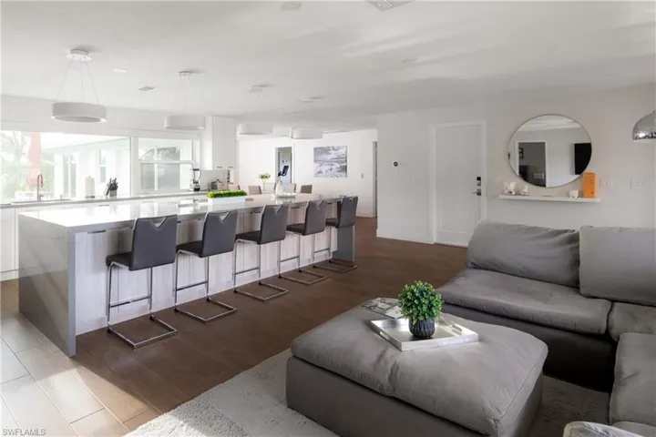 Living room with sink and light hardwood / wood-style flooring