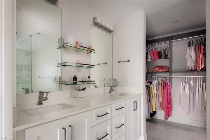 Bathroom featuring walk in shower and vanity