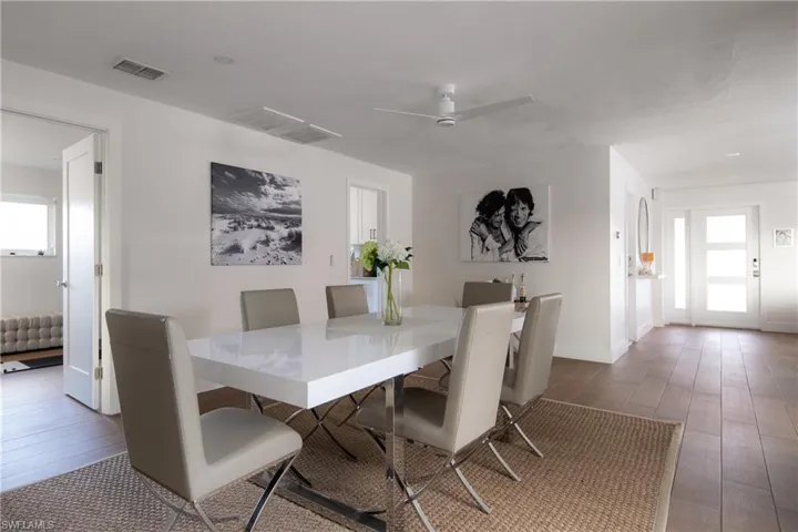 Dining space with hardwood / wood-style flooring, ceiling fan, and a healthy amount of sunlight