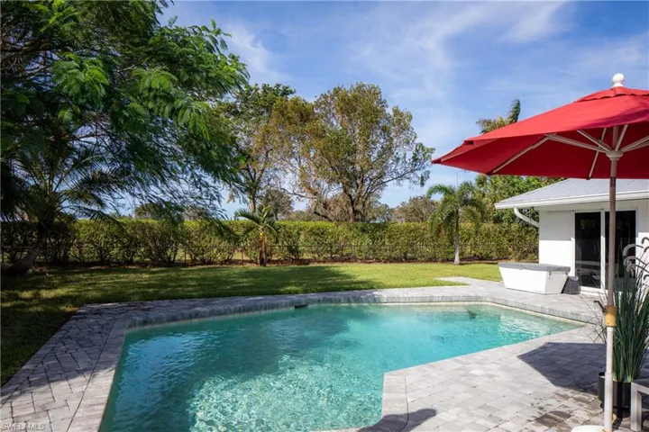 View of swimming pool featuring a patio and a yard