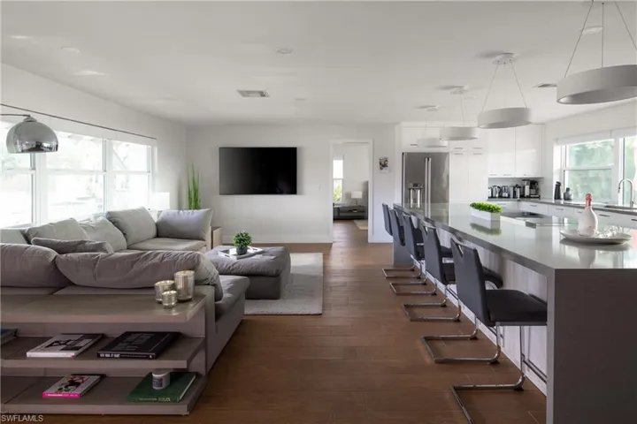Living room with sink and dark hardwood / wood-style flooring