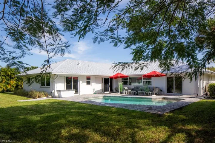 Back of house featuring a yard and a patio area