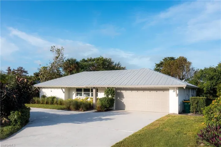 Ranch-style home with a garage and a front yard
