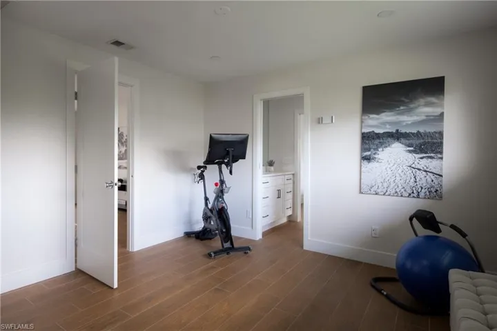 Workout area with hardwood / wood-style flooring