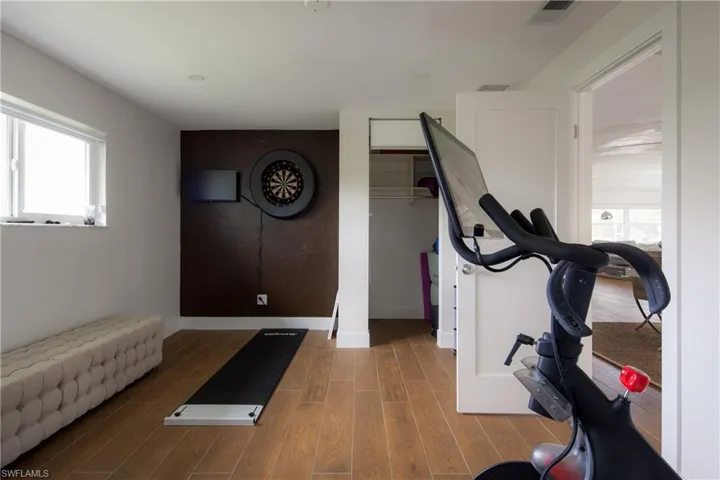 Exercise room featuring hardwood / wood-style floors