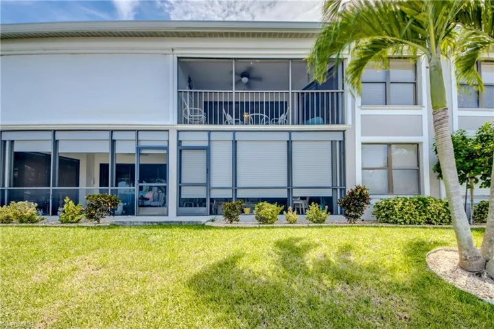 Rear view of property with lovely, mature landscaping
