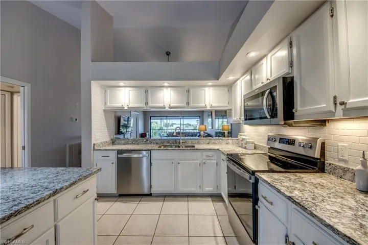 Beautiful granite countertops & convenient dining room pass thru