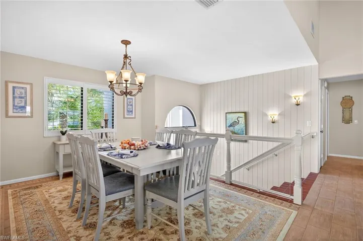 Dining area featuring a classic chandelier and wood-finish flooring